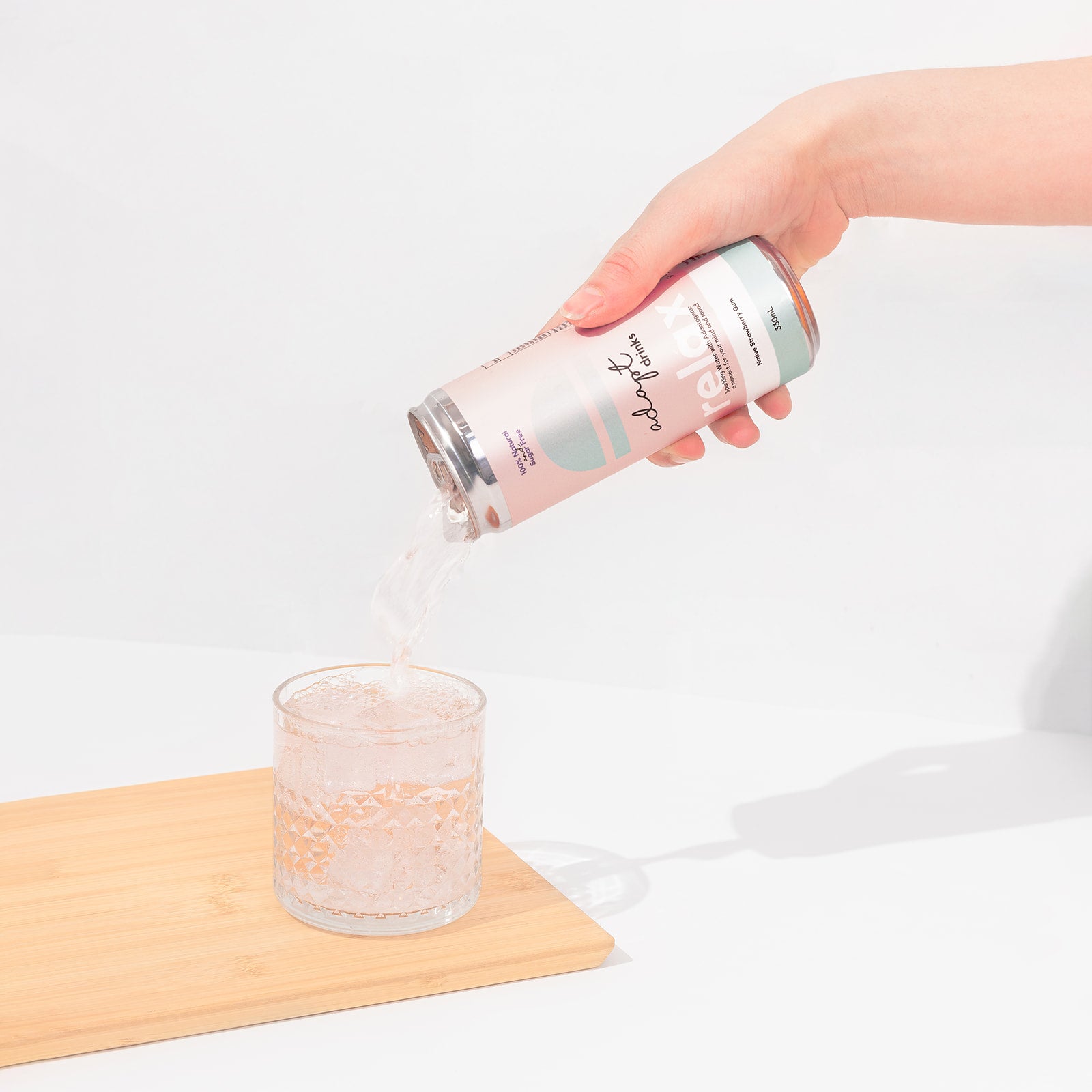 sparkling adaptogenic drinks - native strawberry gum 330mL can being poured into a short glass