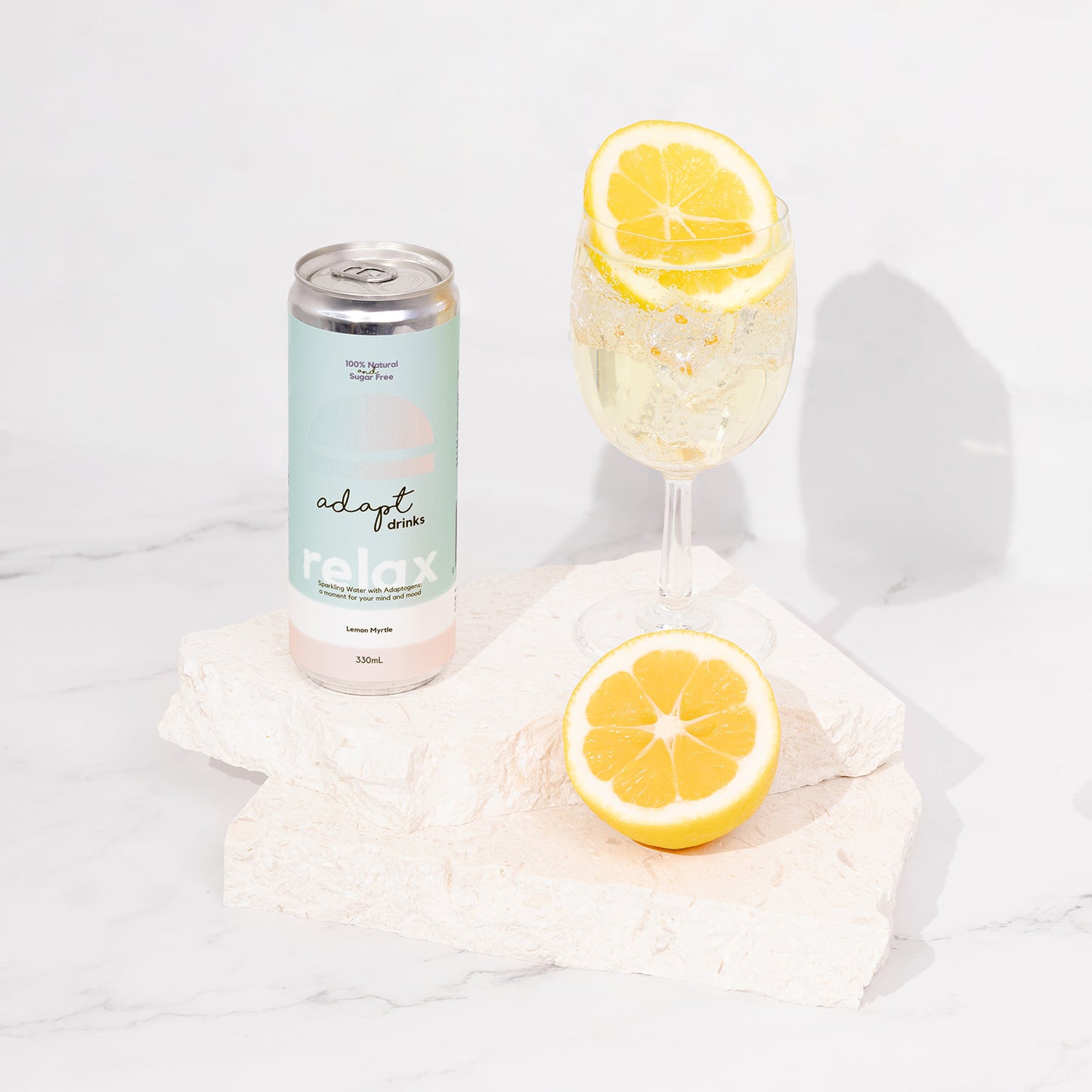 sparkling adaptogenic drinks - lemon myrtle poured into glass with slice of lemon